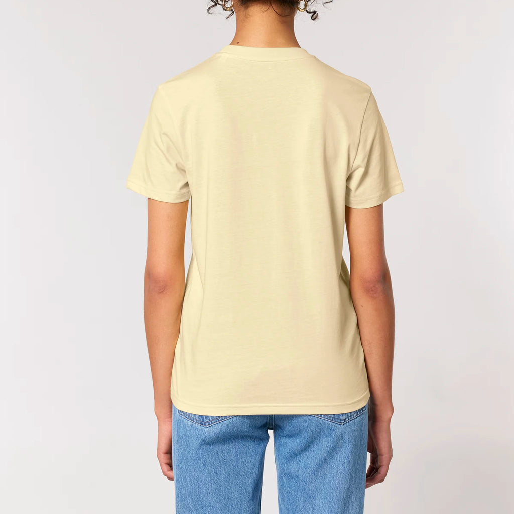 Back view of a female model wearing the TOLS Assigned Vision unisex organic cotton T-shirt in butter color.